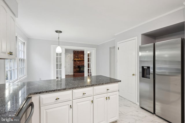 kitchen featuring white cabinets, stainless steel appliances, and dark stone countertops