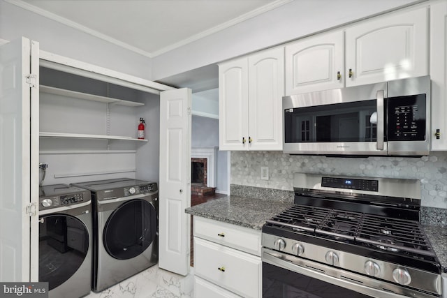 kitchen featuring dark stone countertops, white cabinetry, and appliances with stainless steel finishes