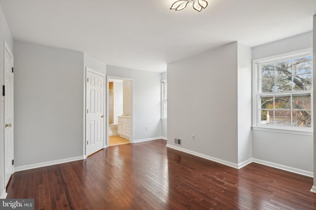 spare room with dark hardwood / wood-style flooring