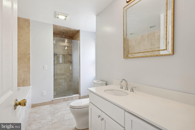 bathroom featuring tile patterned flooring, a shower with door, vanity, and toilet