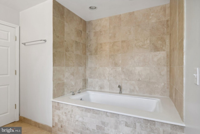 bathroom with a relaxing tiled tub