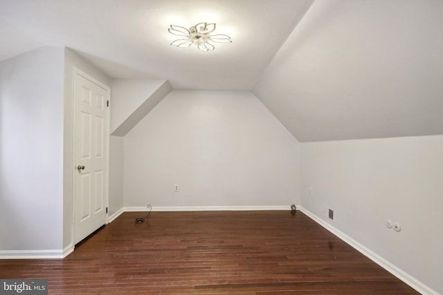 bonus room featuring dark hardwood / wood-style flooring and lofted ceiling