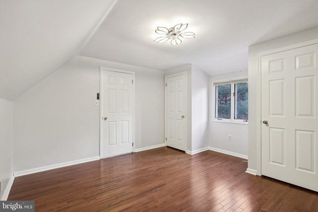 bonus room featuring dark hardwood / wood-style flooring and lofted ceiling