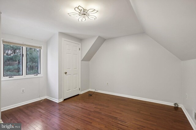 additional living space with dark hardwood / wood-style floors, ceiling fan, and lofted ceiling