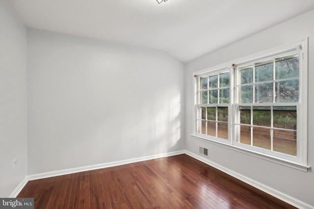 spare room with hardwood / wood-style floors, plenty of natural light, and lofted ceiling