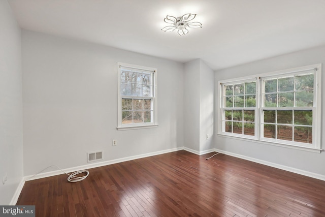 spare room featuring dark hardwood / wood-style floors