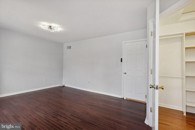 empty room featuring dark wood-type flooring