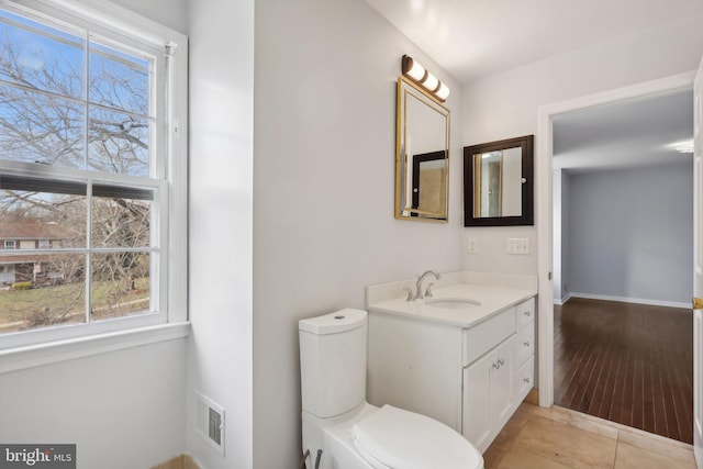 bathroom featuring hardwood / wood-style floors, vanity, and toilet