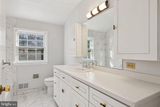 bathroom with vanity, vaulted ceiling, and toilet