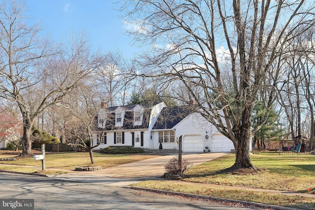 new england style home with a garage and a front yard