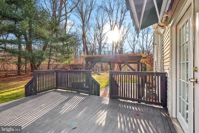 wooden terrace featuring a playground