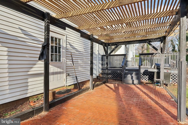 view of patio / terrace with a wooden deck, a pergola, and grilling area