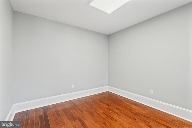 spare room with wood-type flooring