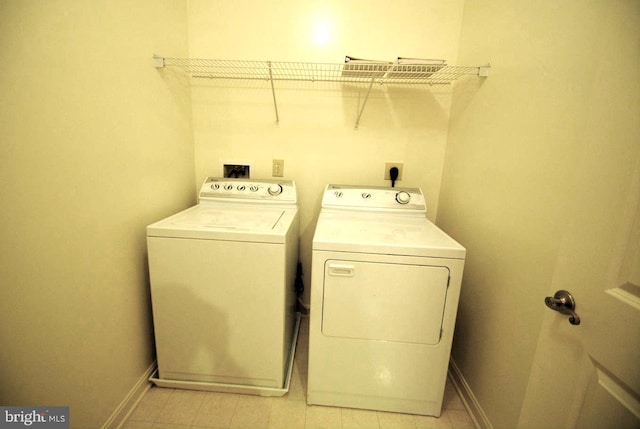 clothes washing area featuring separate washer and dryer