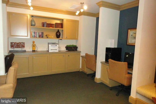 carpeted home office with built in desk and ornamental molding