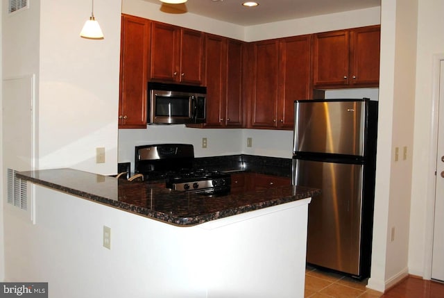 kitchen featuring kitchen peninsula, appliances with stainless steel finishes, light tile patterned floors, and hanging light fixtures