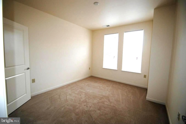 unfurnished room featuring carpet