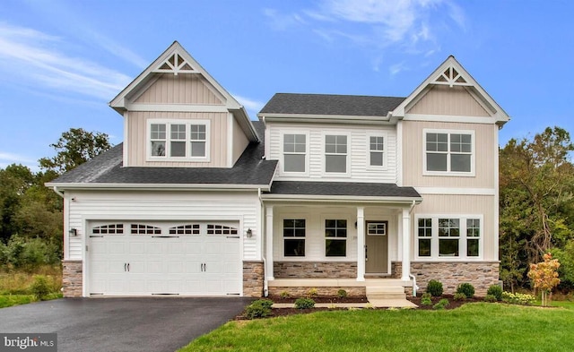 craftsman-style house with a front yard and a garage