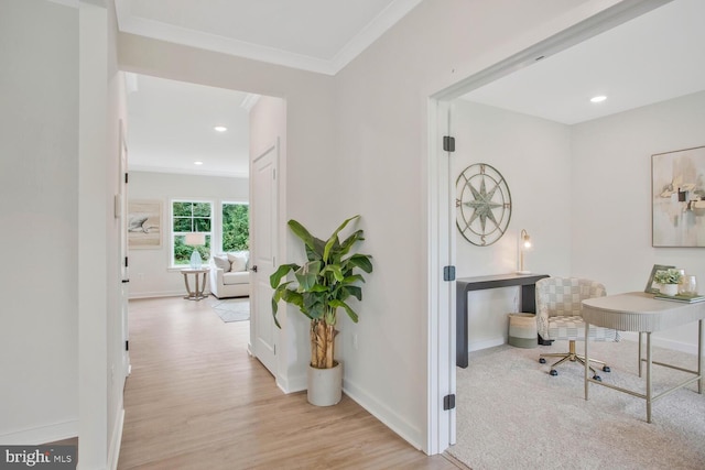 hall featuring light wood-type flooring and ornamental molding