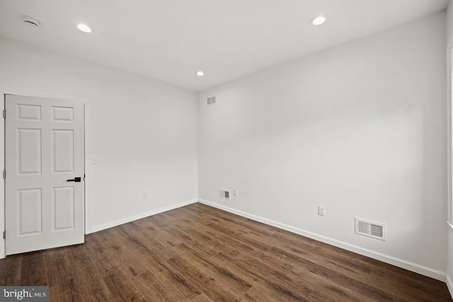 empty room with dark hardwood / wood-style floors