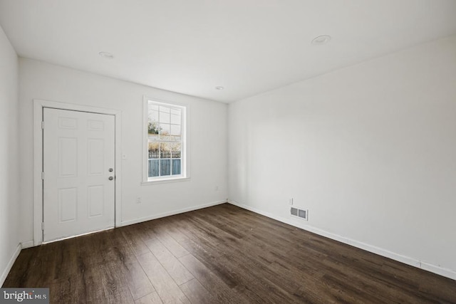 unfurnished room featuring dark wood-type flooring