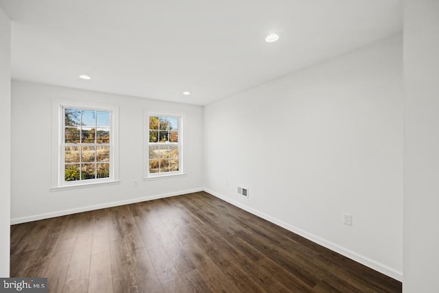 spare room featuring dark wood-type flooring