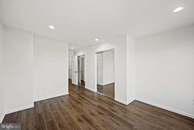 empty room with dark wood-type flooring