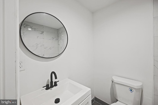 bathroom featuring vanity and toilet