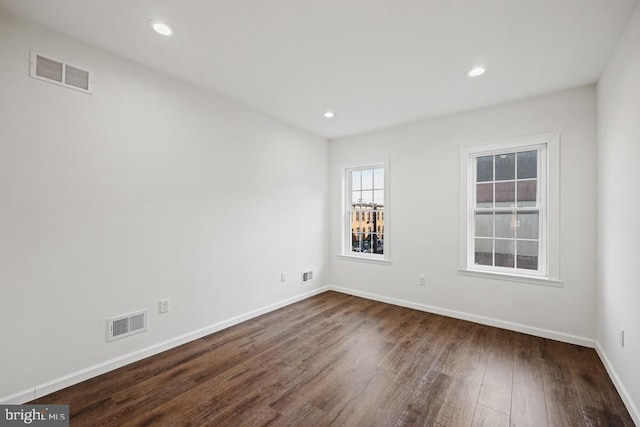 empty room with dark hardwood / wood-style flooring