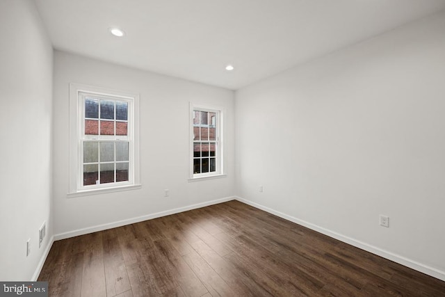 empty room with dark wood-type flooring