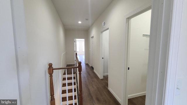 corridor with dark hardwood / wood-style flooring