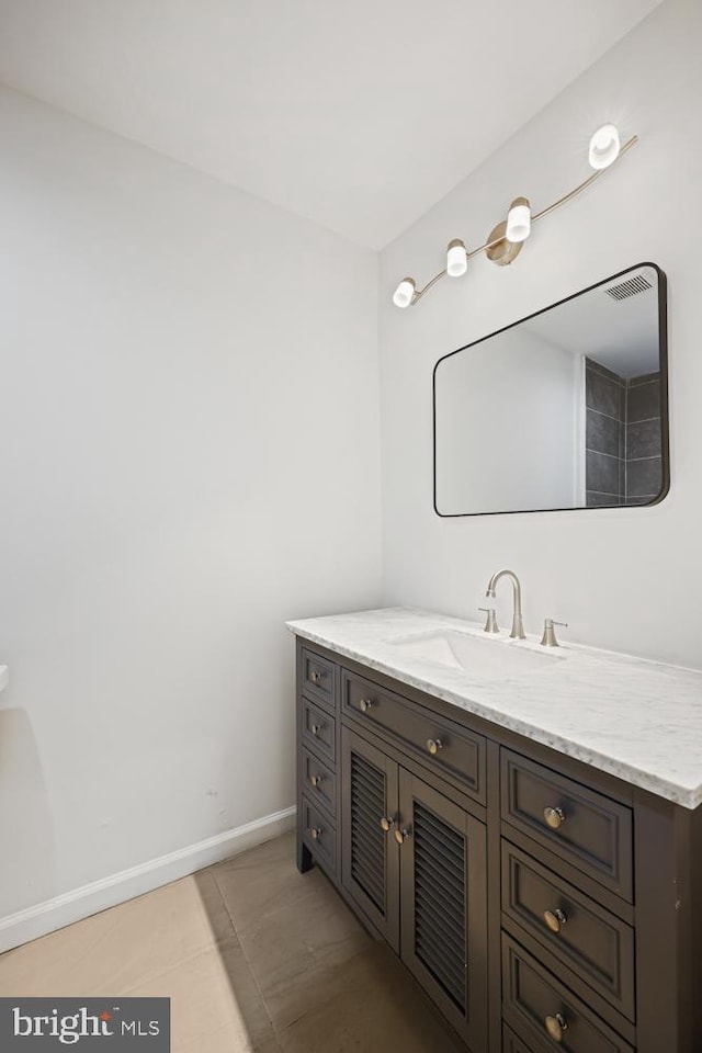 bathroom with tile patterned flooring and vanity