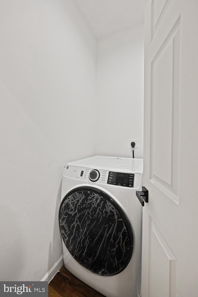 washroom with washer / clothes dryer and dark wood-type flooring