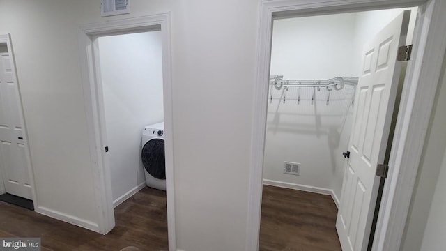 clothes washing area featuring washer / clothes dryer and dark wood-type flooring