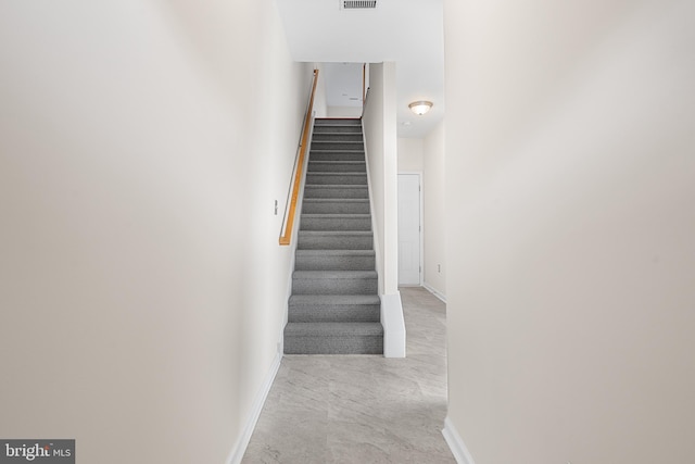 staircase featuring visible vents and baseboards