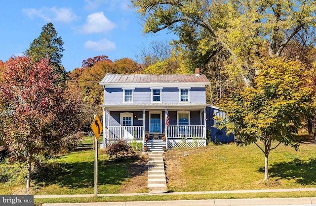 view of front of house with a front yard and covered porch