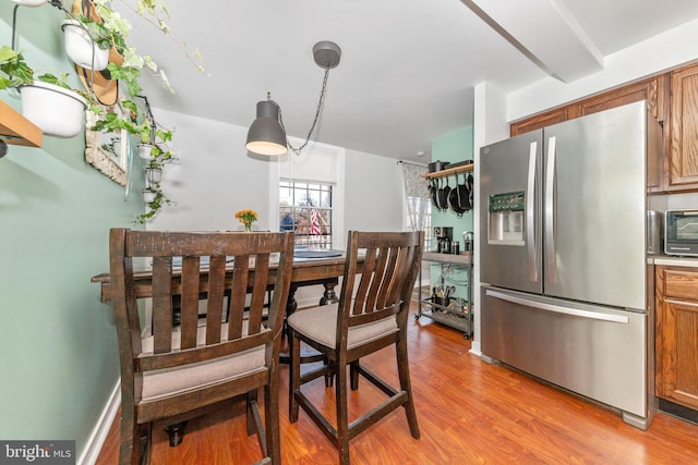 dining space featuring light wood-type flooring