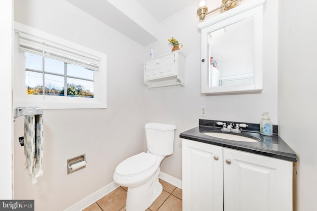 bathroom featuring toilet, vanity, and tile patterned floors