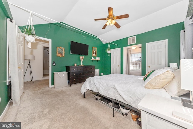 carpeted bedroom featuring ceiling fan and lofted ceiling