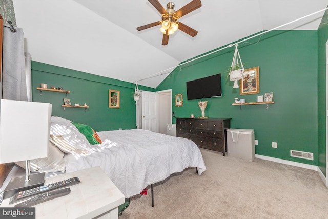 carpeted bedroom with ceiling fan and vaulted ceiling