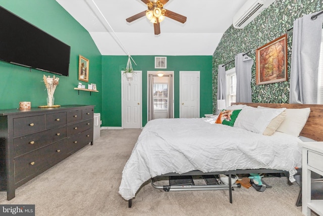 carpeted bedroom featuring a wall mounted air conditioner, ceiling fan, and lofted ceiling