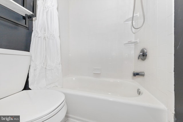 bathroom featuring shower / bath combination with curtain and toilet