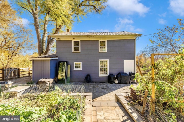 rear view of house with a patio