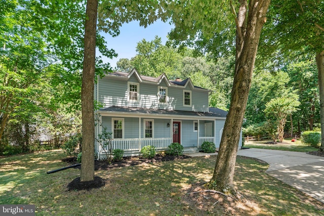 view of front of home featuring covered porch and a front yard