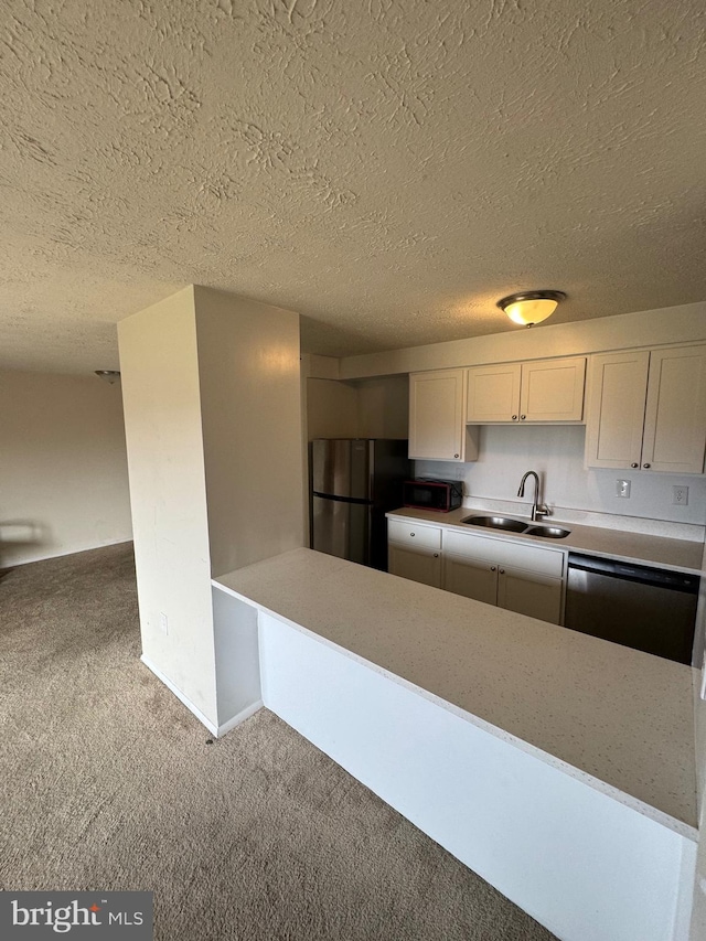 kitchen featuring light colored carpet, sink, white cabinetry, and stainless steel appliances