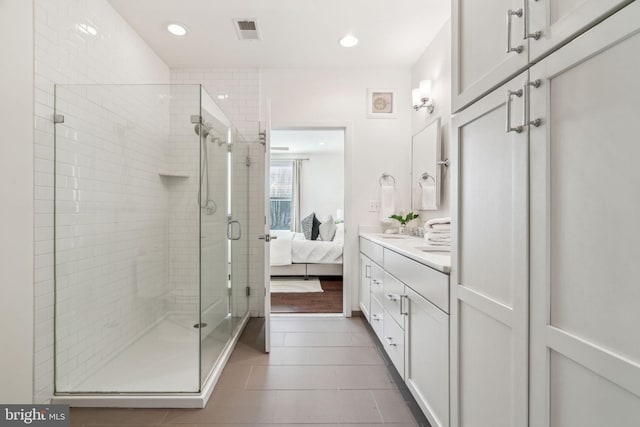 bathroom with tile patterned floors, visible vents, connected bathroom, and a shower stall