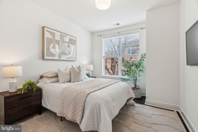 bedroom with visible vents and baseboards