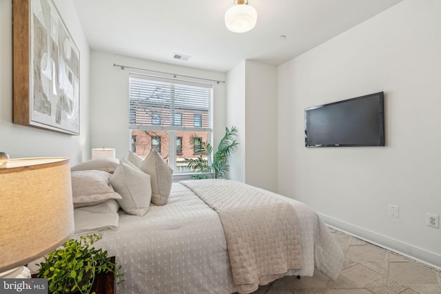 bedroom with visible vents and baseboards