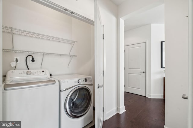 laundry area featuring laundry area, dark wood-type flooring, baseboards, and separate washer and dryer