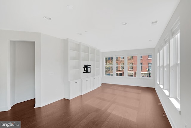 unfurnished living room with recessed lighting, wood finished floors, and visible vents